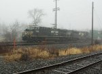 NS 8026 heads west in the fog on 27P